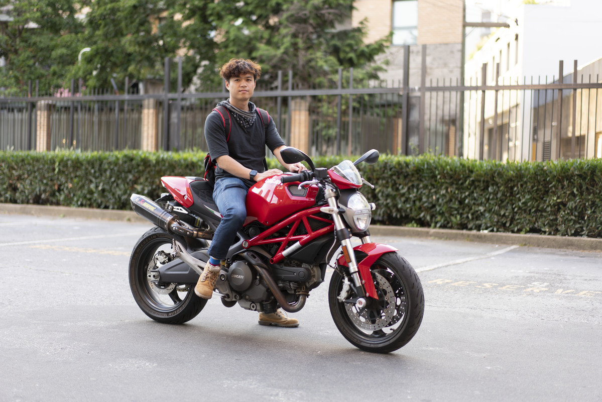 James riding a motorbike that is a Ducati Monster 696
